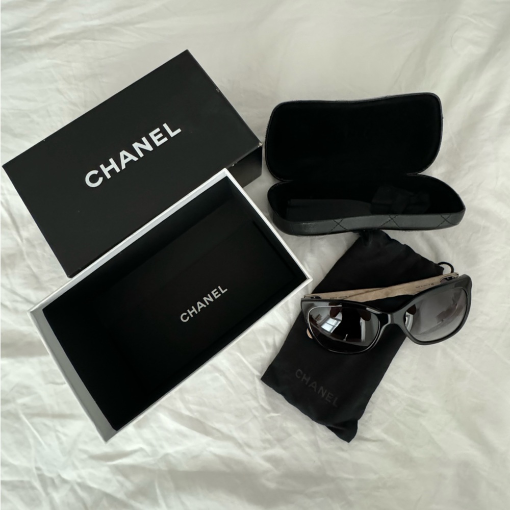 CHANEL Black Sunglasses with cream quilted legs.